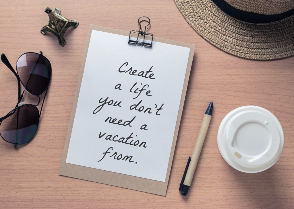 Inspirational motivating quote on notebook and travel objects with vintage filter